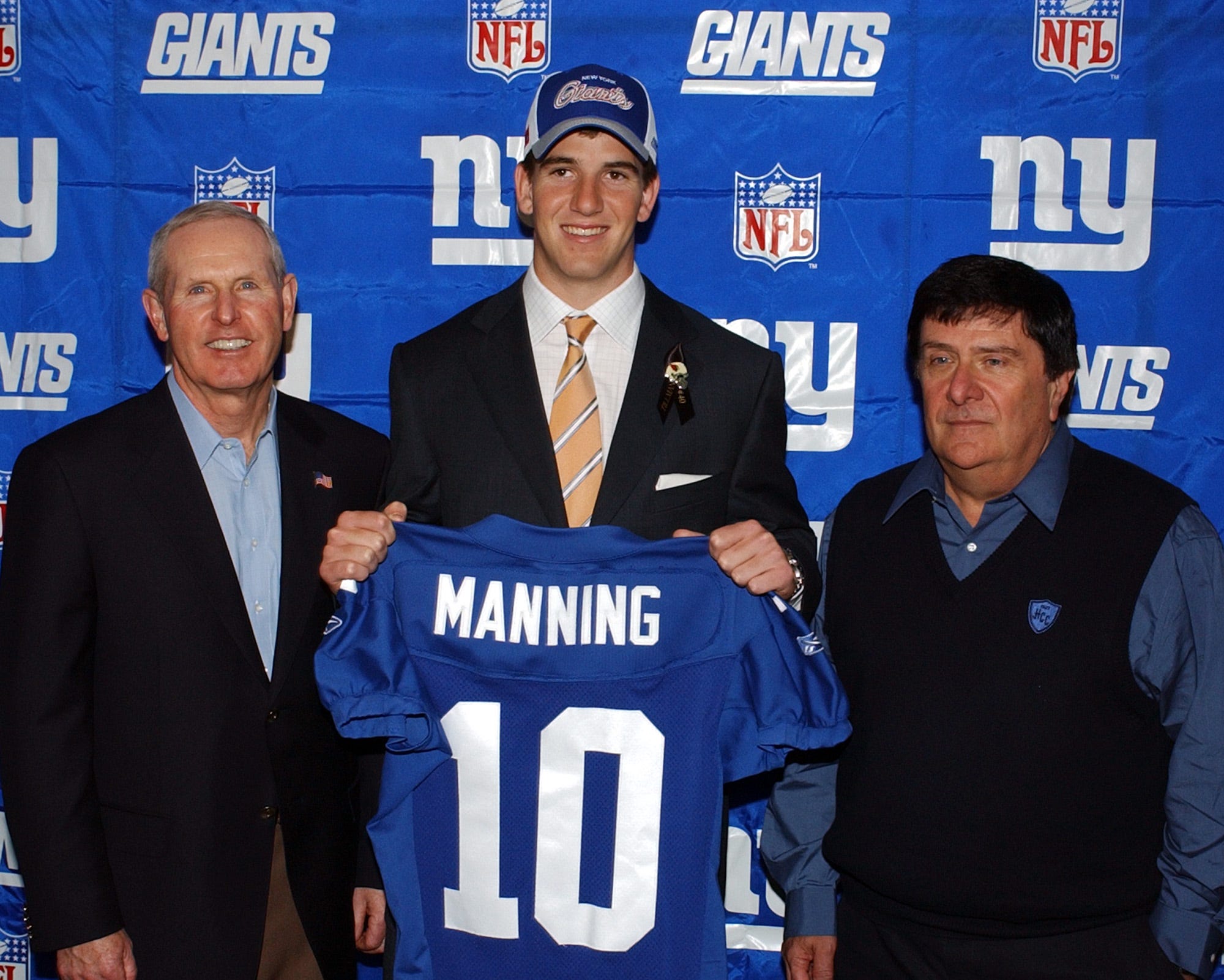 eli manning holding chargers jersey